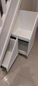 Under stairs storage incorporating pull out drawers.