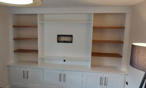 Matt white media wall with Shaker doors, a classic and elegant design by Roy Newton Furniture in Staffordshire.