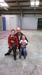 Roy and his family in the empty unit after picking up the keys.