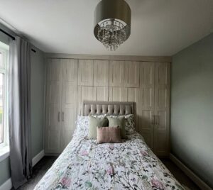 Nordic white bedroom in caraway classic doors designed with a bed in front.